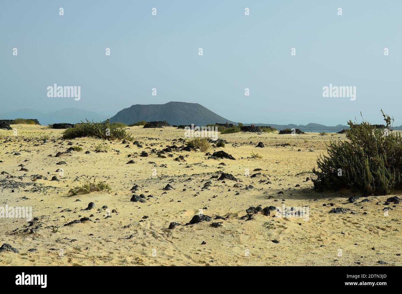 Spain, Canary Island, Fuerteventura, rocky beach with Los Lobos island behind Stock Photo
