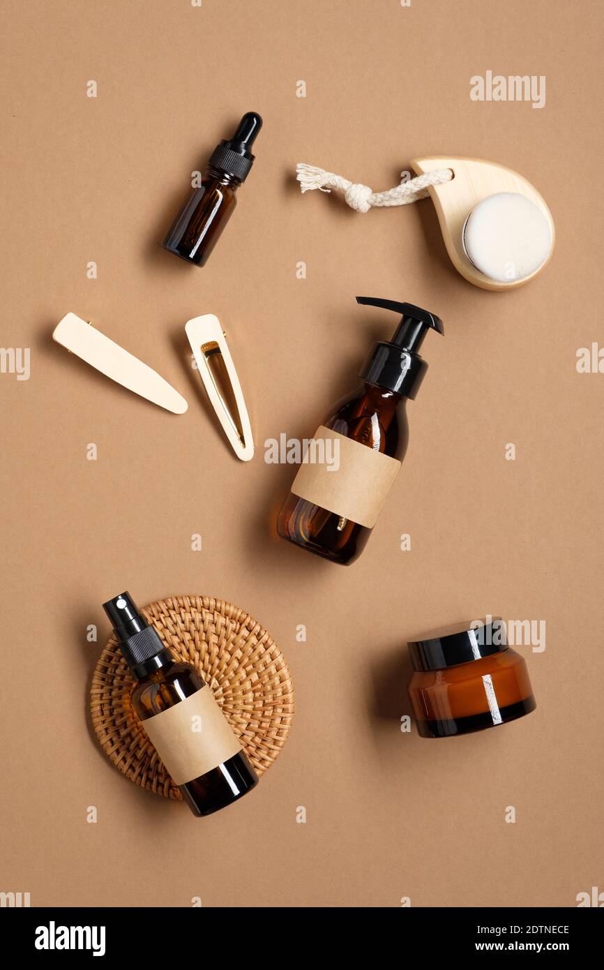 Amber glass bottles with blank labels mockup and female accessories on