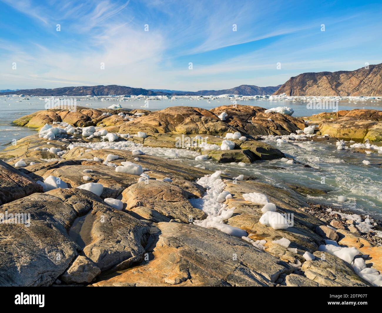 Shoreline littered with icebergs from Eqip Glacier (Eqip Sermia or Eqi Glacier) in Greenland. Polar Regions, Denmark, August Stock Photo