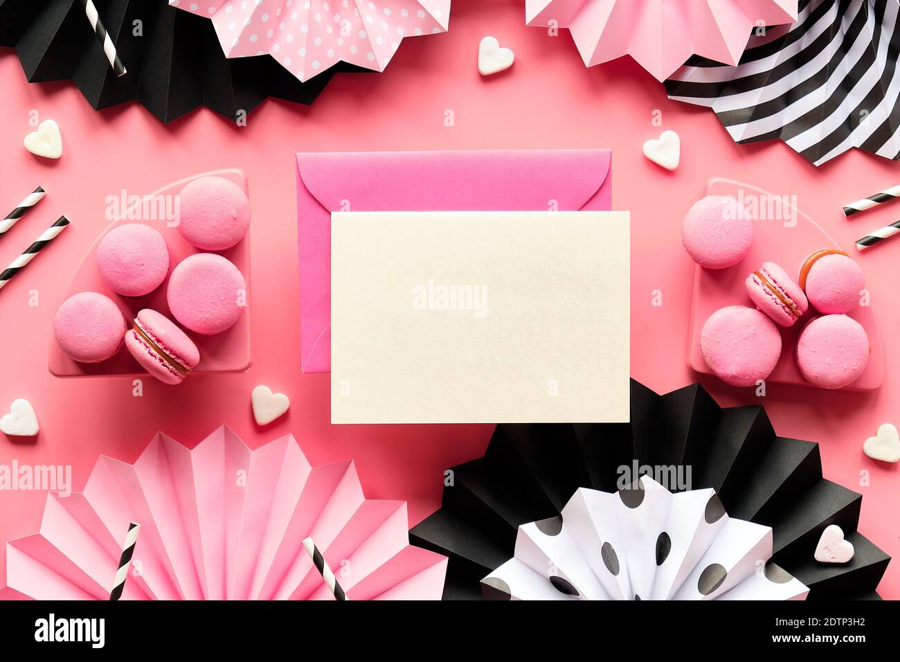 Card with copy-space and envelope. Happy Birthday Sweet and tasty macaroons and coffee. Creative monochrome flat lay on pink color paper. Folded paper Stock Photo