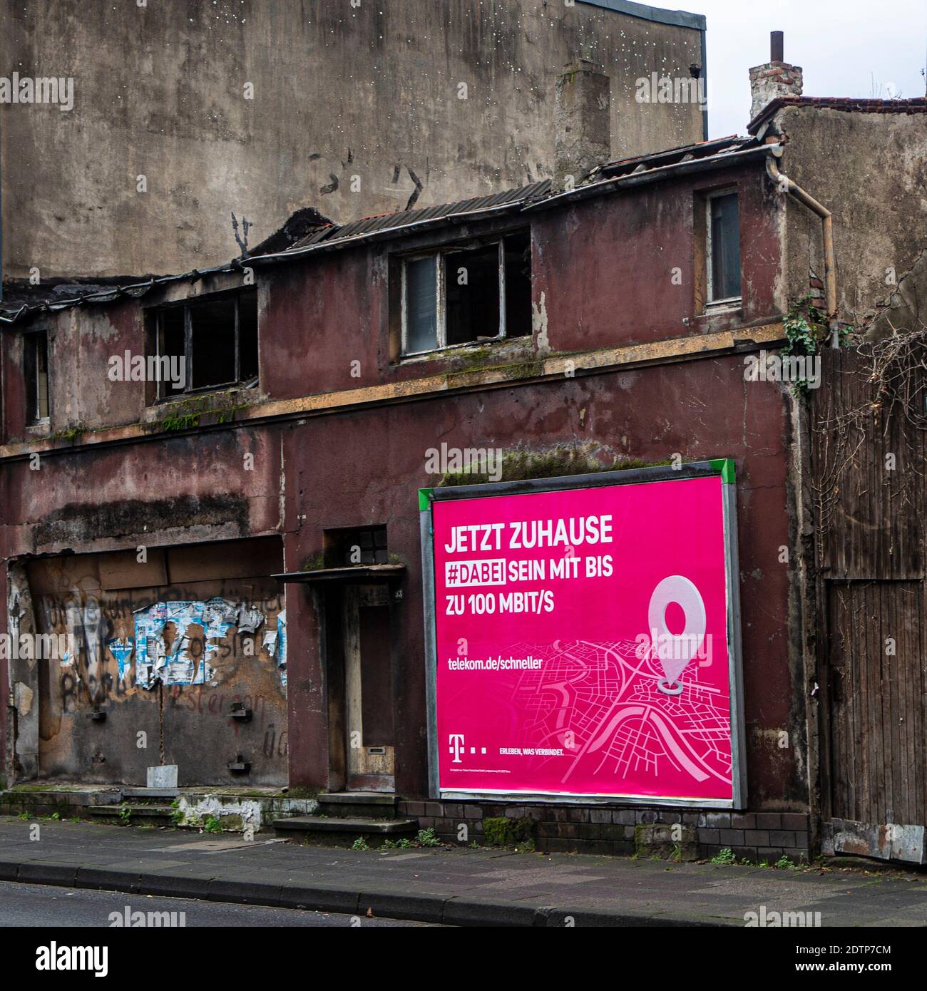 Reklame an Trümmerhäusern in Duisburg. Die Telekom wirbt mit 'jetzt zuhause' , wo kein zu hause mehr ist. Stock Photo