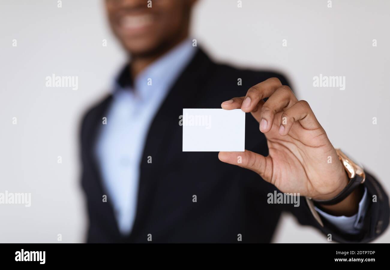 Empty card in african american man hands, selective focus Stock Photo