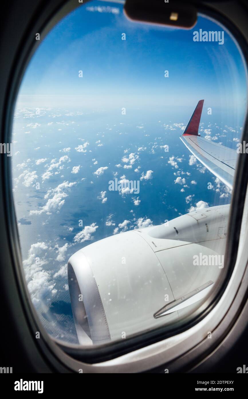 Window view from inside the aircraft during the flight over the ocean. Stock Photo