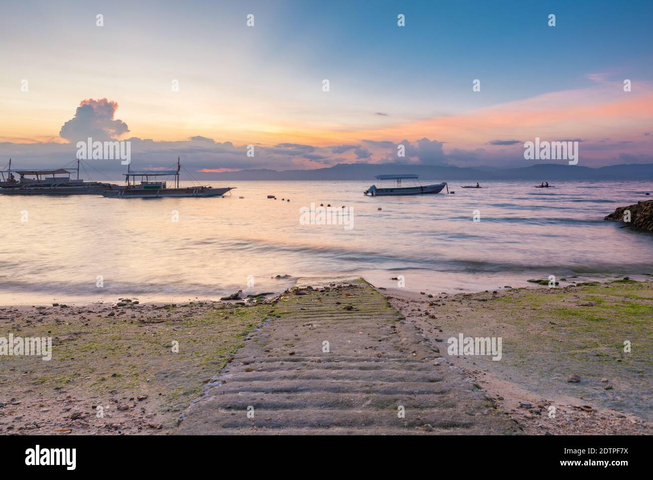 Sunset view of the Moalboal beach famous diving and snorkeling spot in Cebu with Negros island on the background, Philippines Stock Photo
