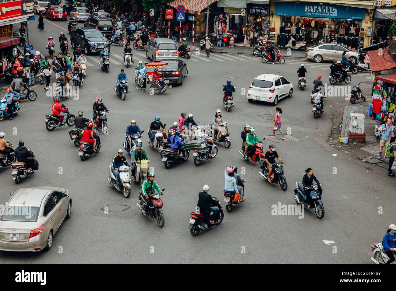 Hanoi, Vietnam - October 16, 2018: View of a famous chaotic traffic at the Dong Kinh Nghia Thuc Square in the Old Quarter of Hanoi. Stock Photo