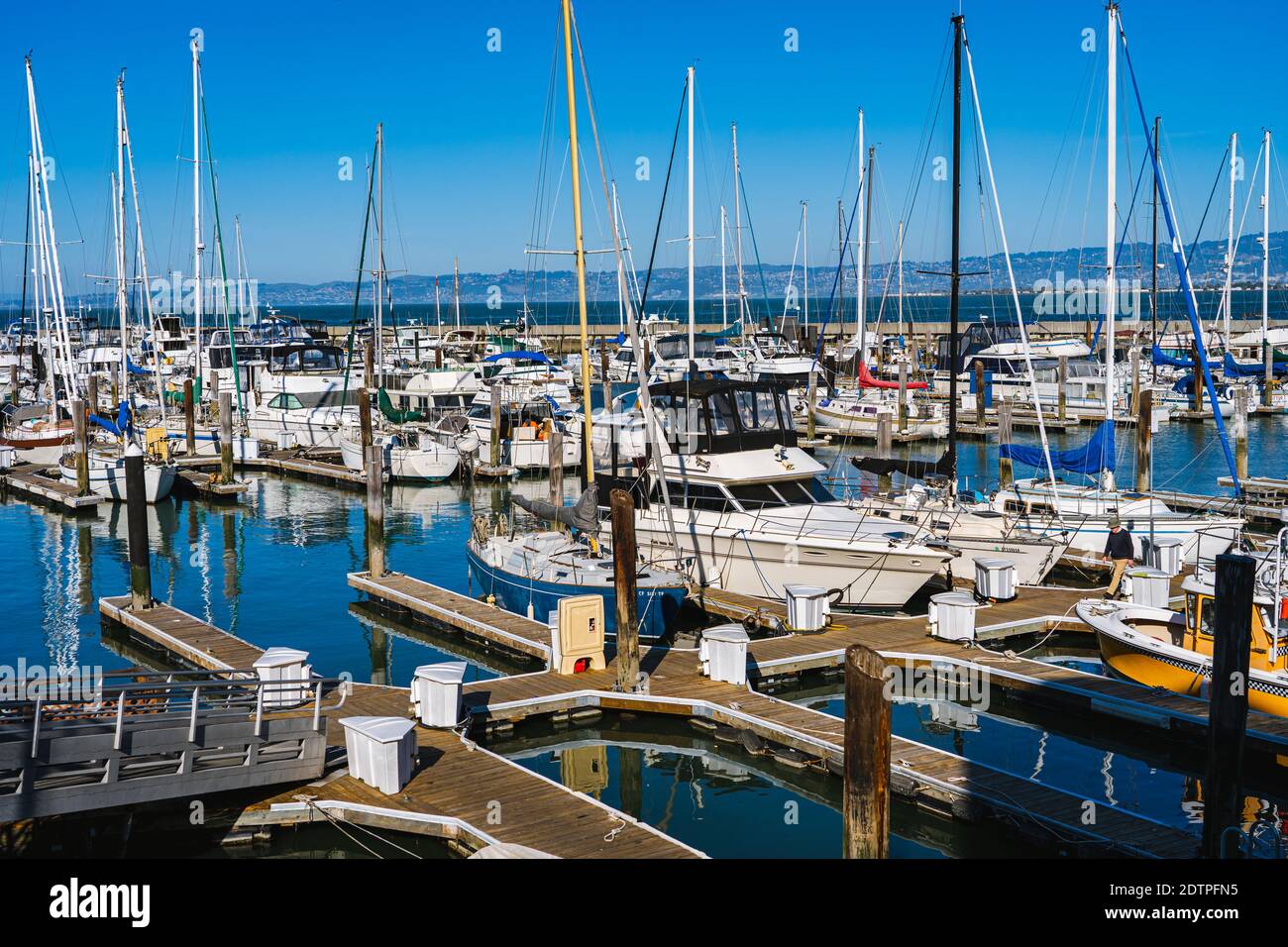 Pier 39 houses 300 double-fingered wooden dock boat slips available for long-term rental, day stays, and overnight guest docking. Stock Photo