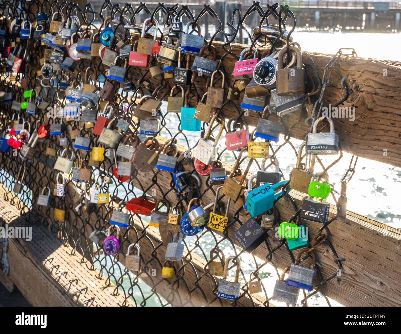 The colorful display of padlocks on Pier 39 in San Francisco represents the declaration of an unbreakable bond for many couples. Stock Photo