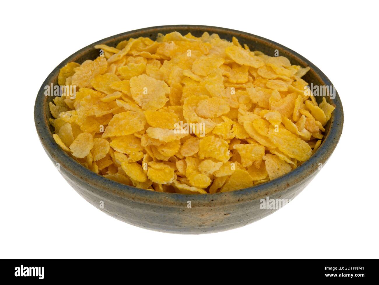 Side view of a bowl of dry toasted corn cereal isolated on a white background. Stock Photo