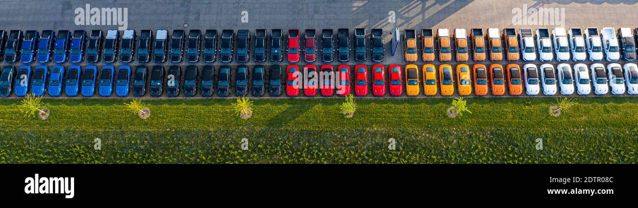 Aerial view of a car distribution centre, new cars parked in rows on a lot ready for sale.  Stock Photo