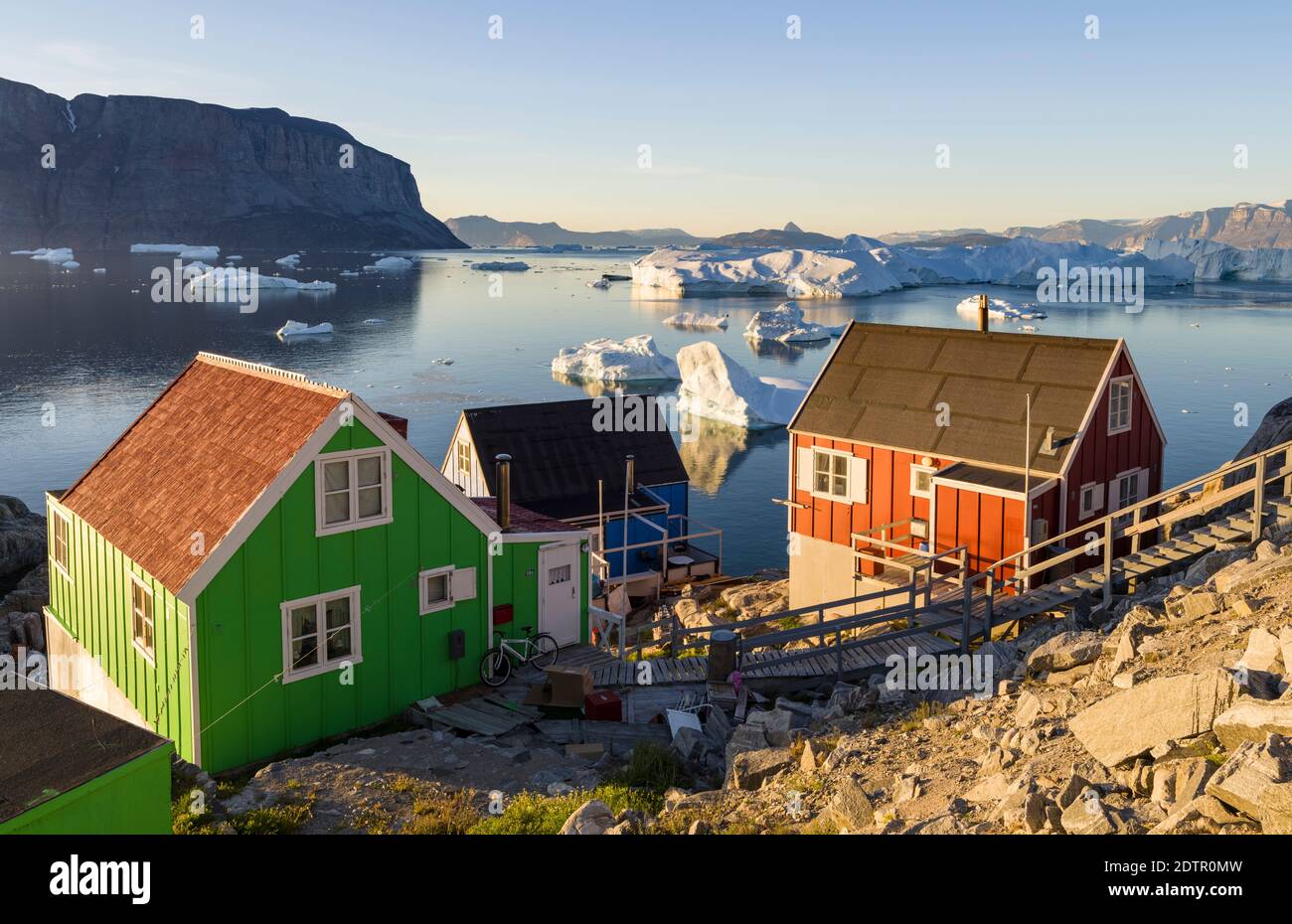 View of fjord full of icebergs towards Nuussuaq (Nugssuaq) peninsula during midnight sun. The town Uummannaq in the north of West Greenland, located o Stock Photo