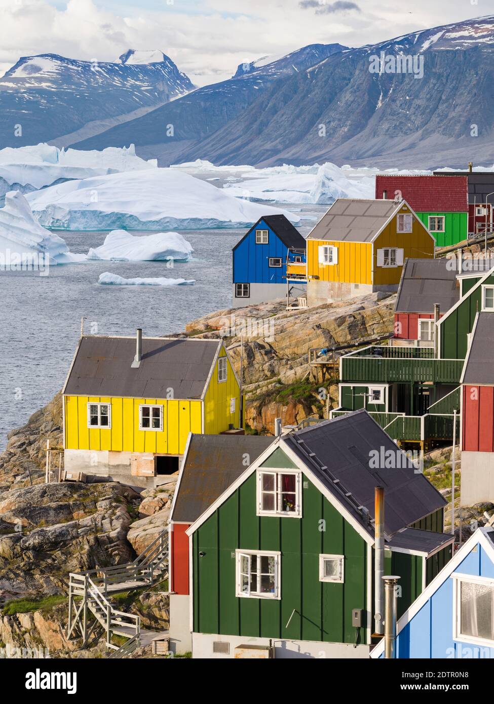 The town Uummannaq in the north of West Greenland, located on an island  in the Uummannaq Fjord System, in background the Nuussuaq (Nugssuaq) Peninsul Stock Photo