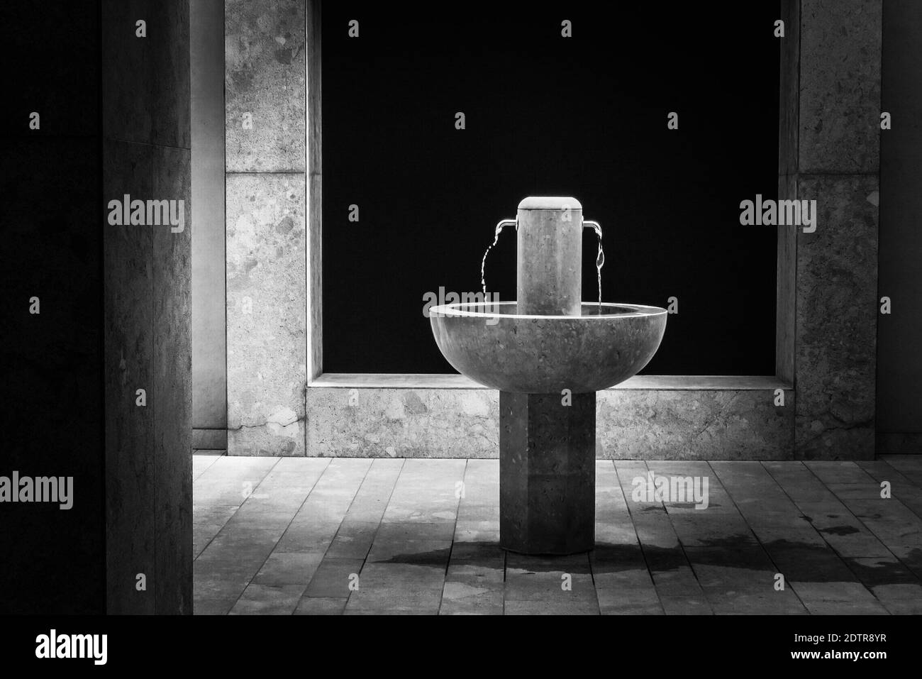 Fountain On Tiled Floor Against Wall In Building Stock Photo