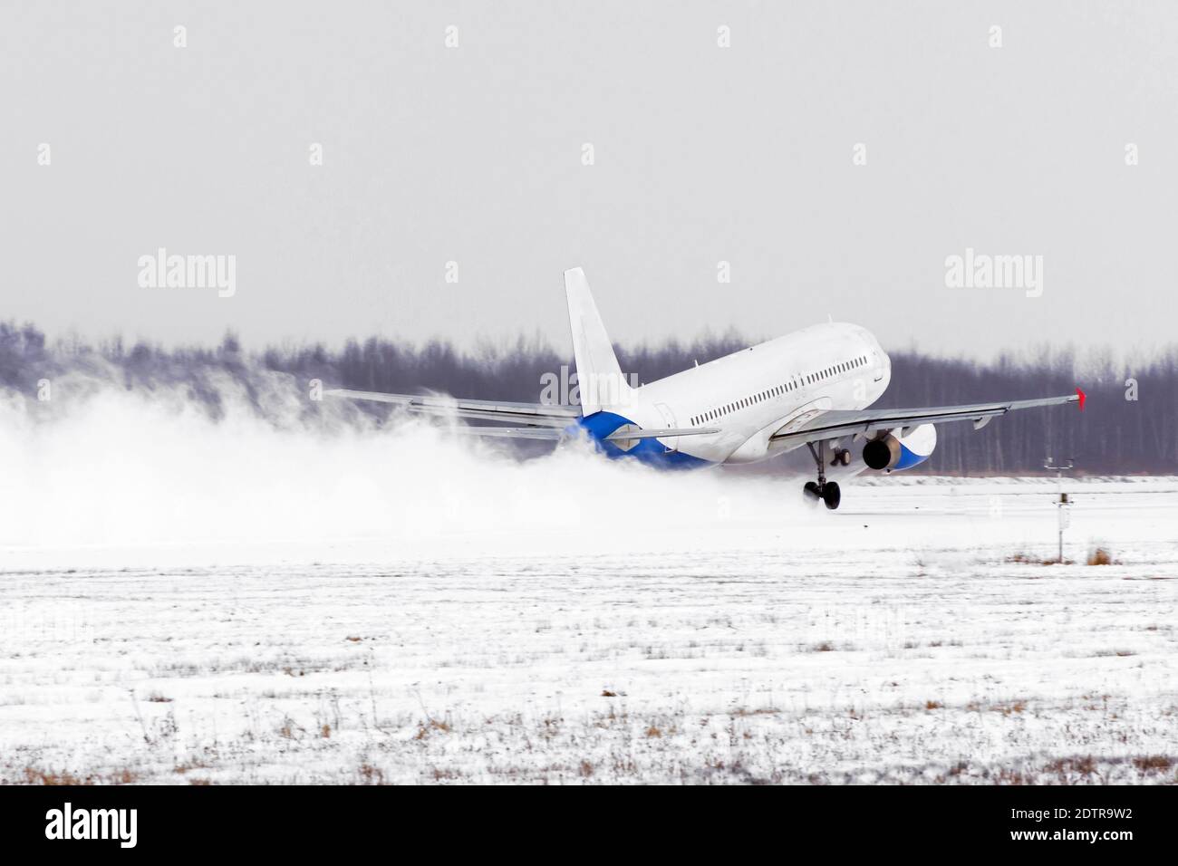 Airplane take off from the snow-covered runway airport in bad weather  during a snow storm, a strong wind in the winter Stock Photo - Alamy