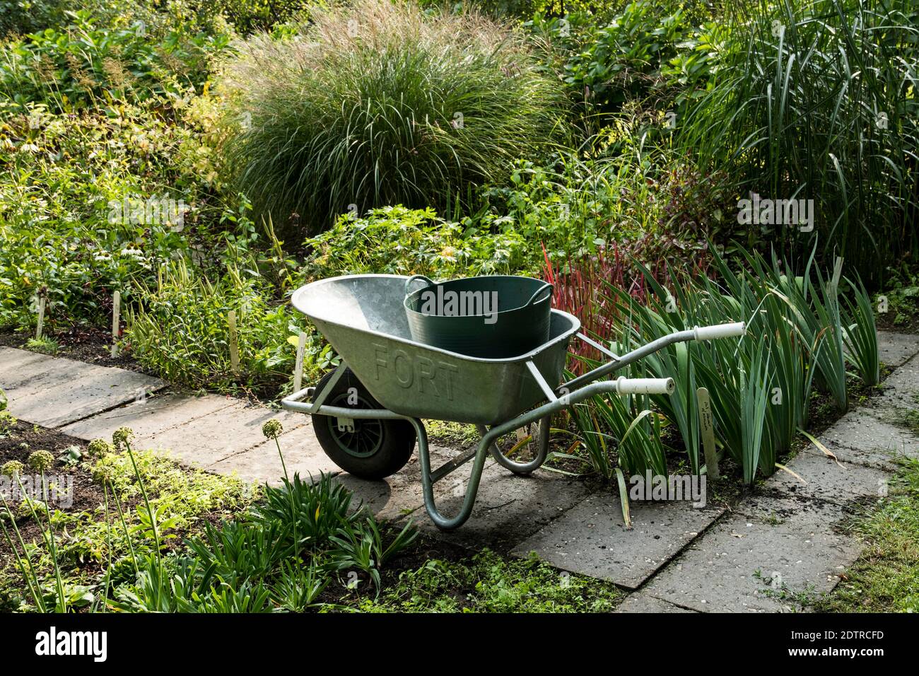 Wheel barrow in the garden Stock Photo Alamy