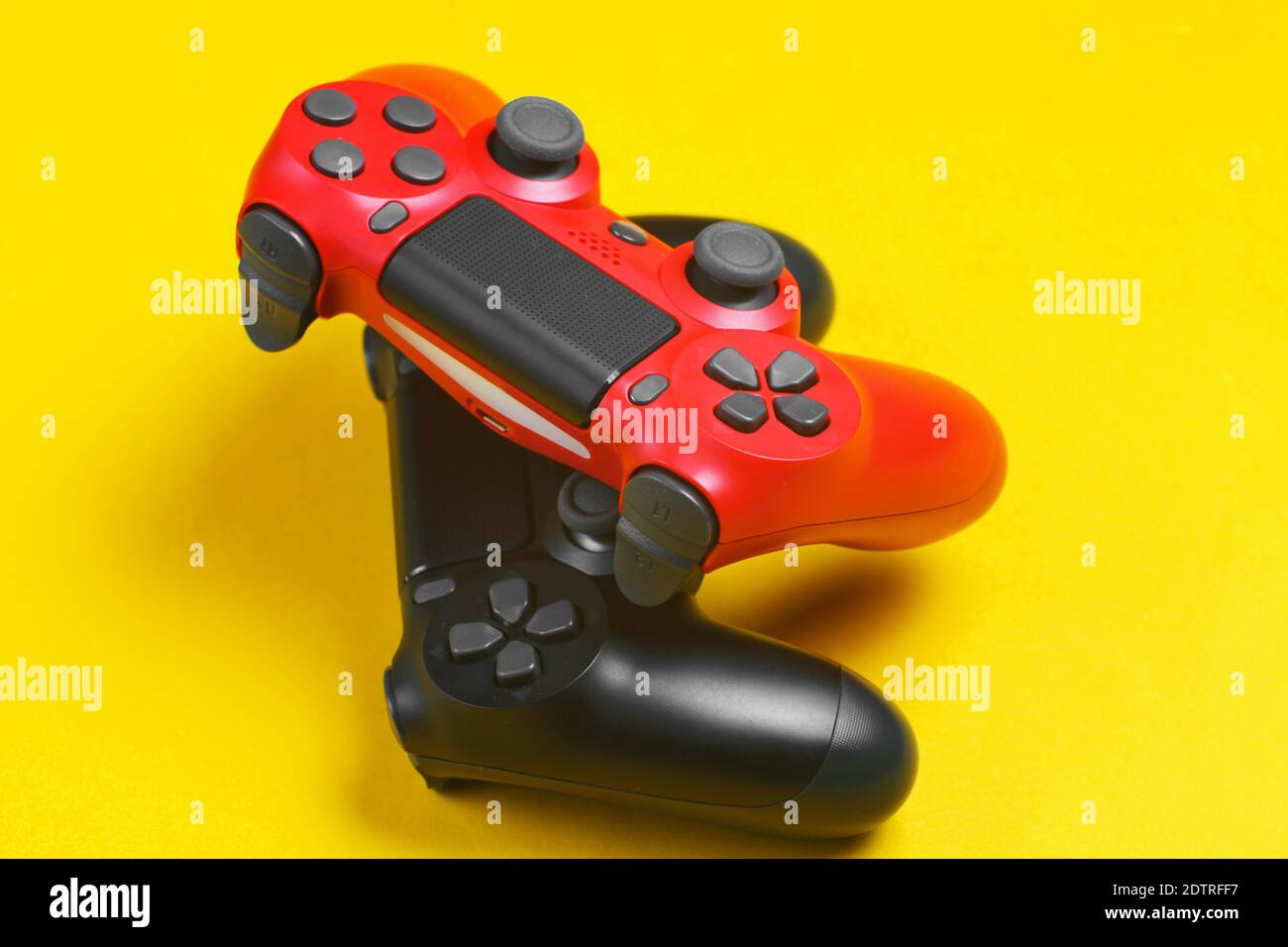 Two gamepad on yellow background close up Stock Photo - Alamy