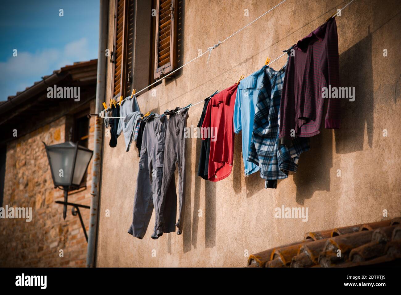 A shot of clothing hanging on the washing line to dry on a sunny dya Stock Photo