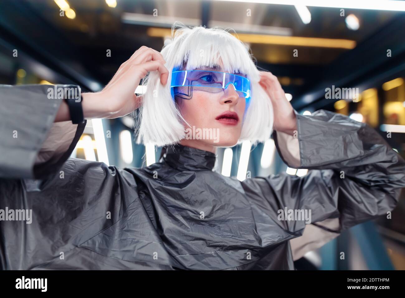 Woman from the future in futuristic glasses and clothes. Stock Photo
