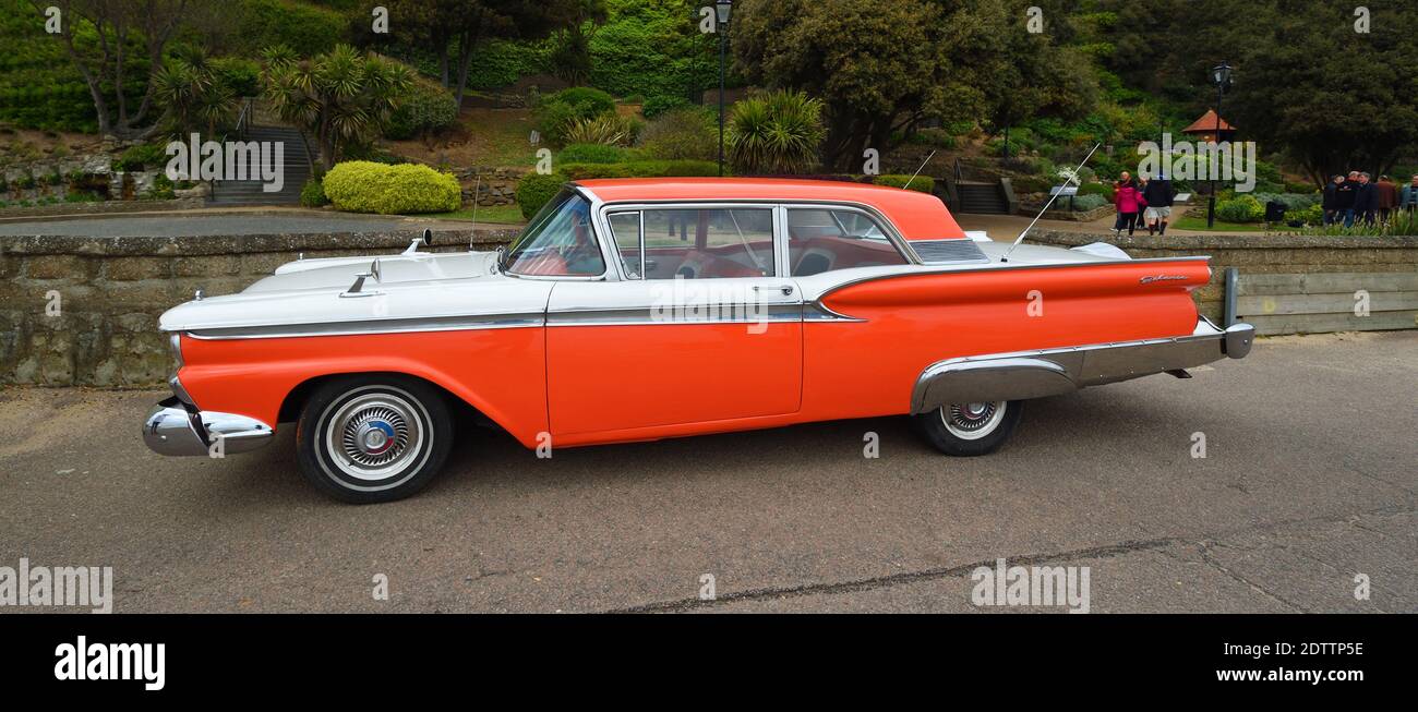 Classic American Ford Galaxie automobile parked in front of trees. Stock Photo