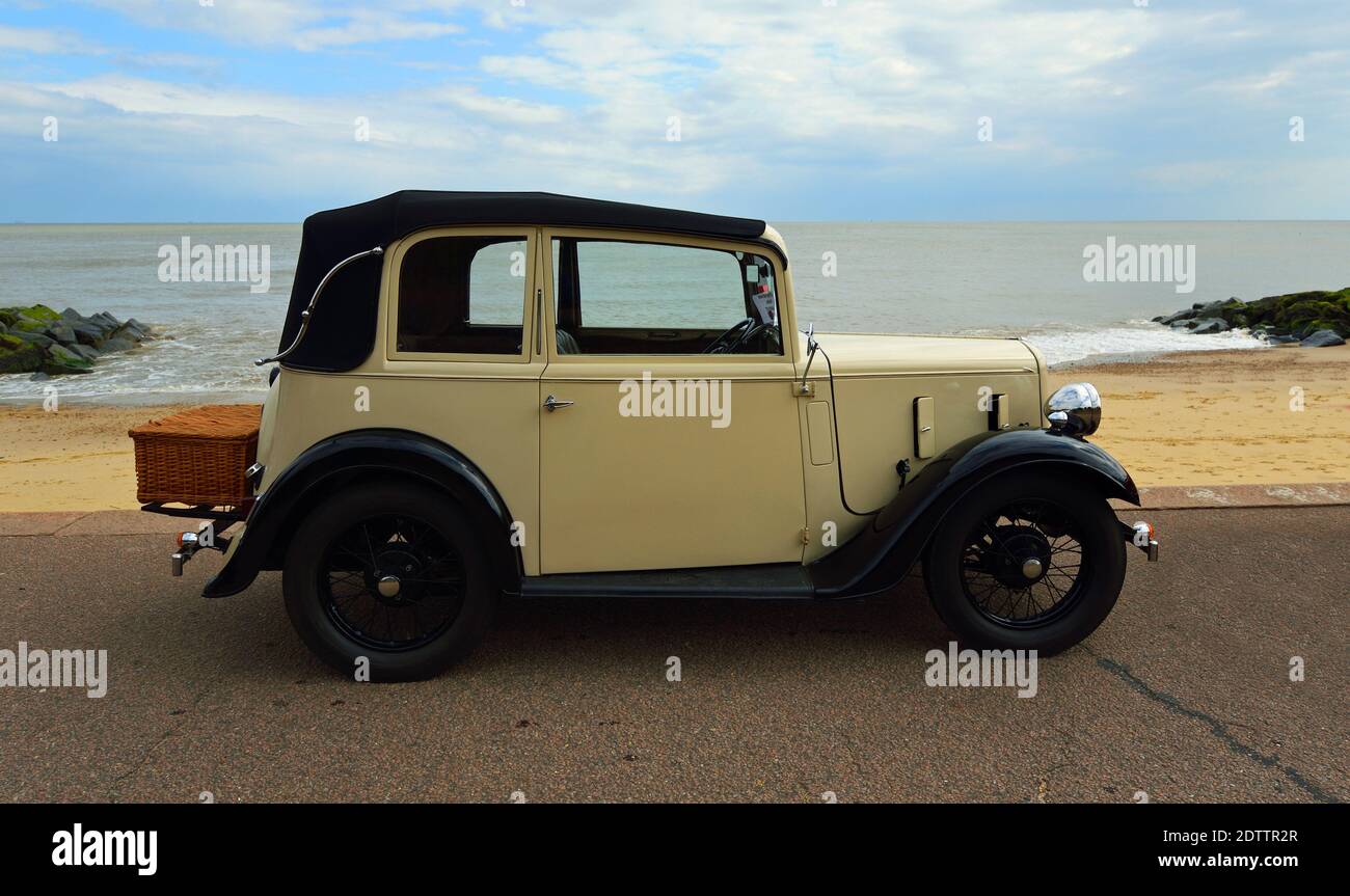 Vintage Cream Coloured Austin Seven with basket on back  Parked on Seafront Promenade Stock Photo
