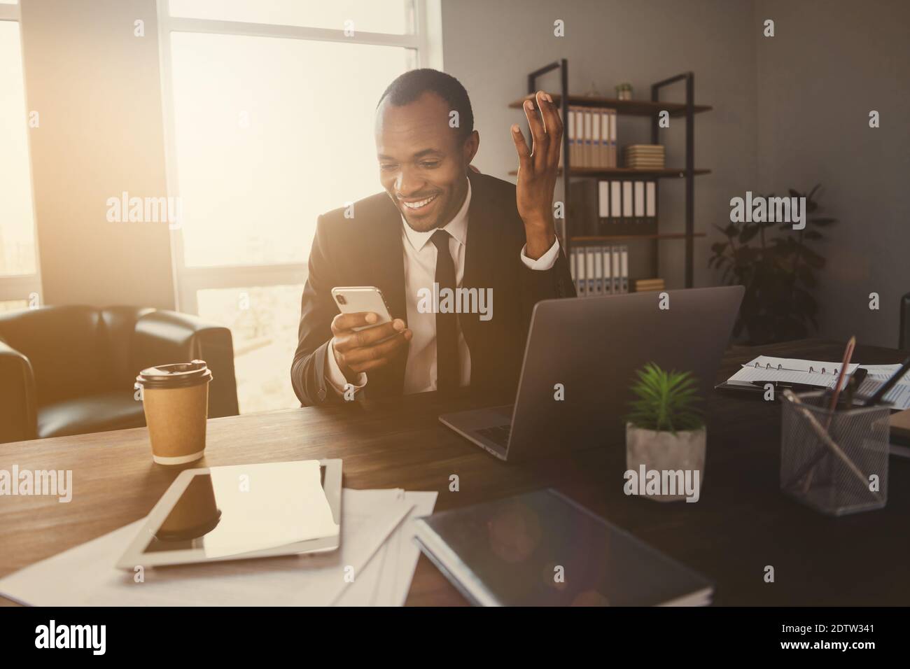 Portrait of positive afro american man ceo worker sit desk use ...