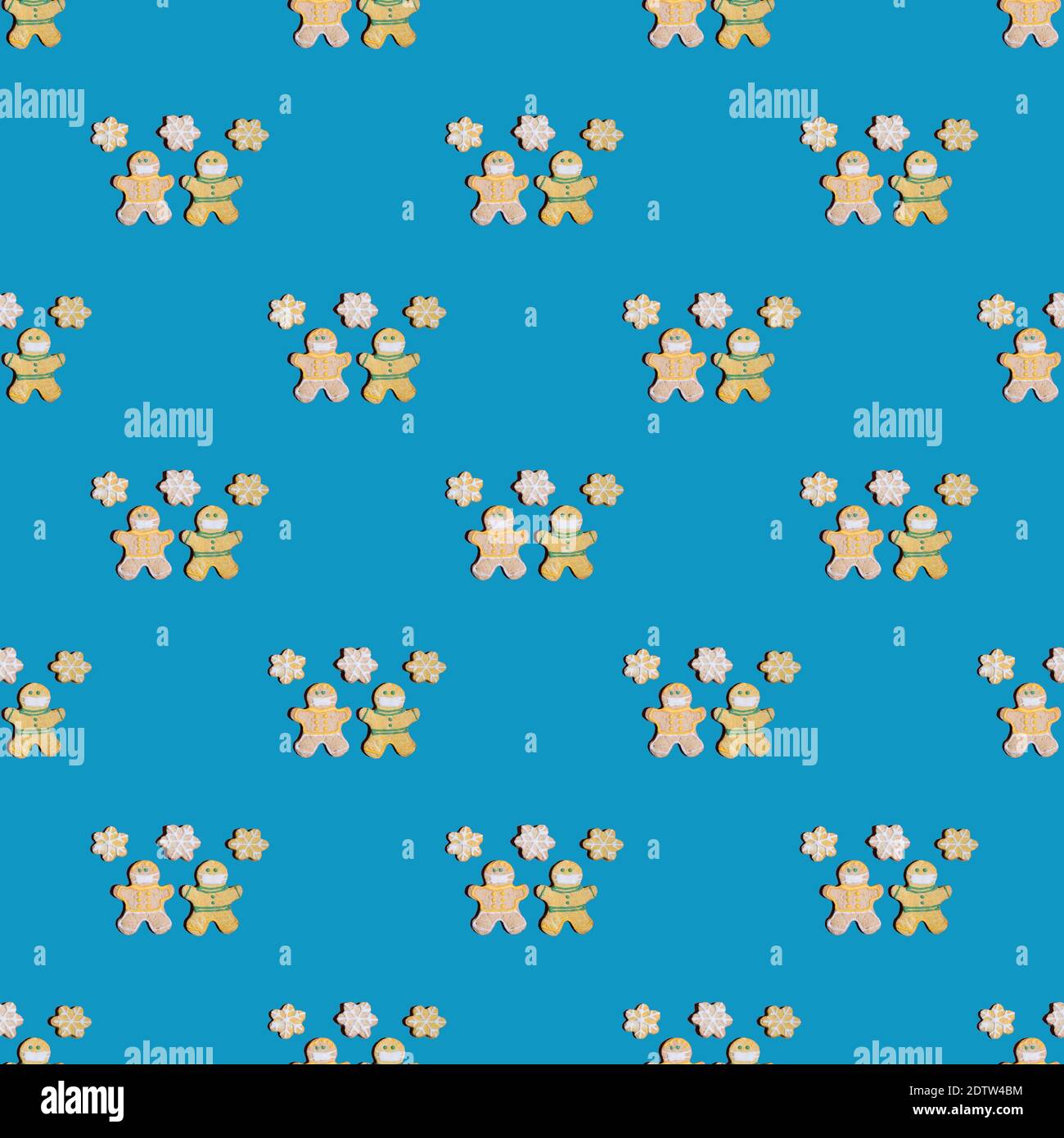 Seamless pattern with people in protective masks with snowflakes on a blue background. Stock Photo