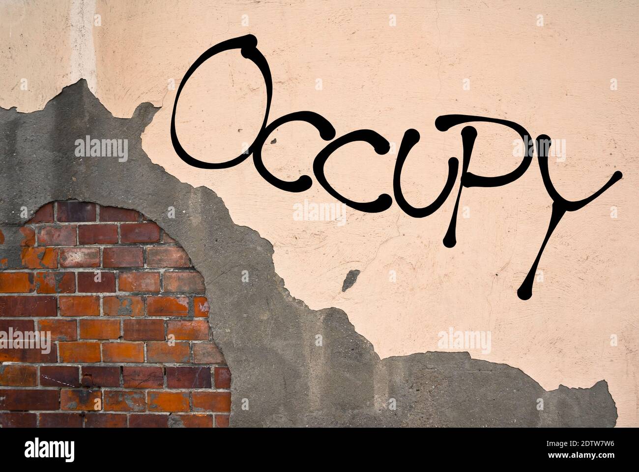 Handwritten graffiti Occupy sprayed on the wall, anarchist aesthetics Stock Photo