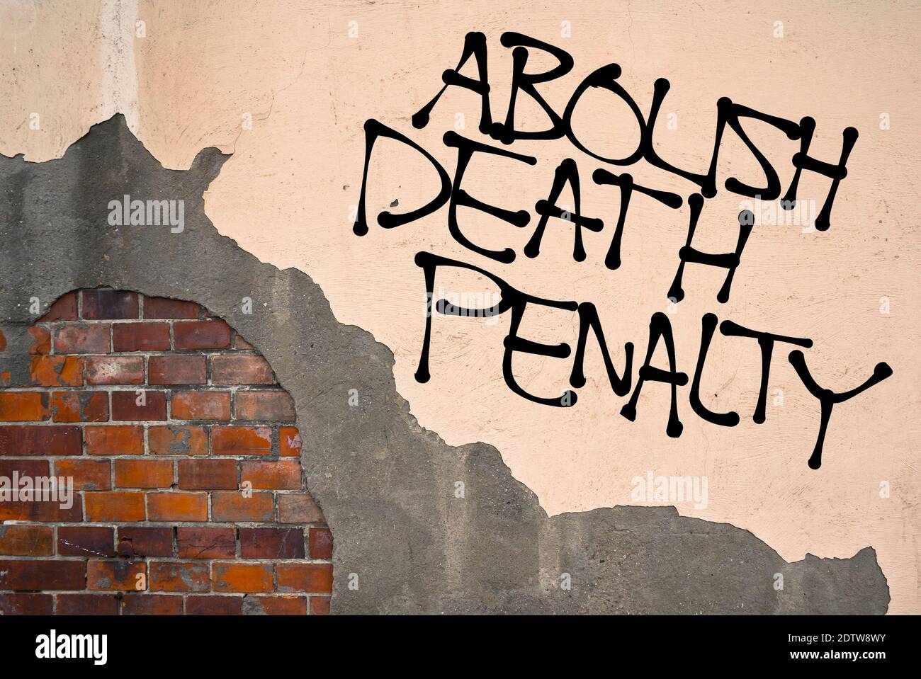 Handwritten graffiti Abolish Death Penalty sprayed on the wall, anarchist aesthetics. Appeal to stop capital punishment and executions on defendants Stock Photo
