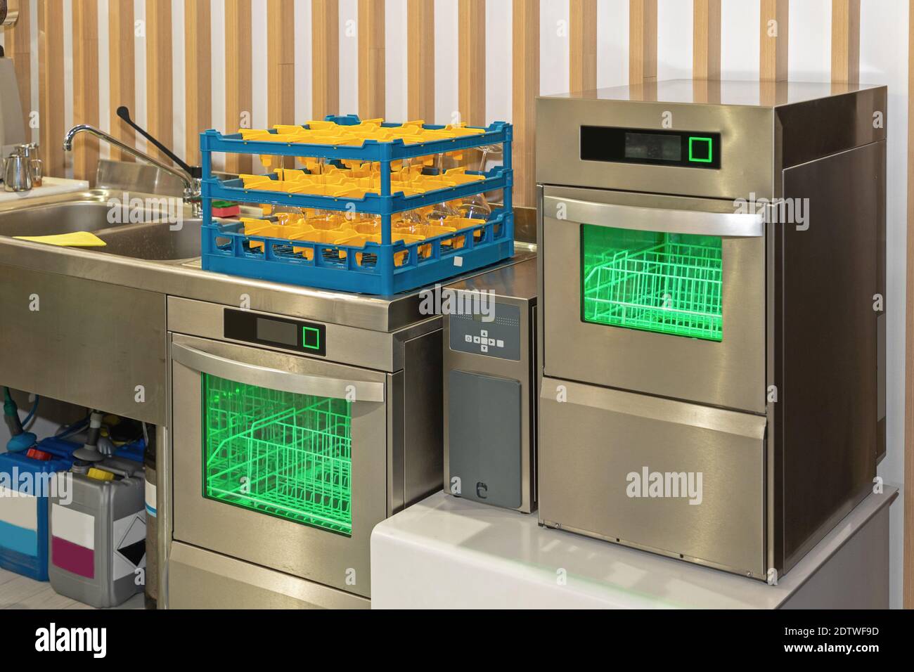 Two Dishwasher Machines With Glass Rack in Restaurant Kitchen Stock
