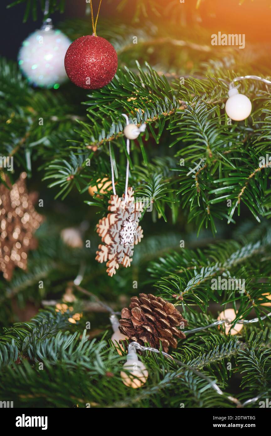 Christmas ornament on pine tree branch with lights blurred background Stock Photo