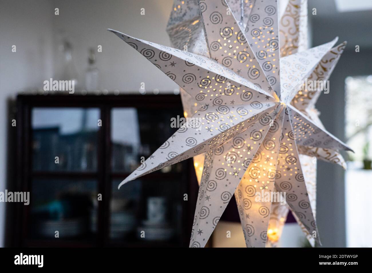 Illuminated paper stars serve as a christmas decoration in a modern home Stock Photo