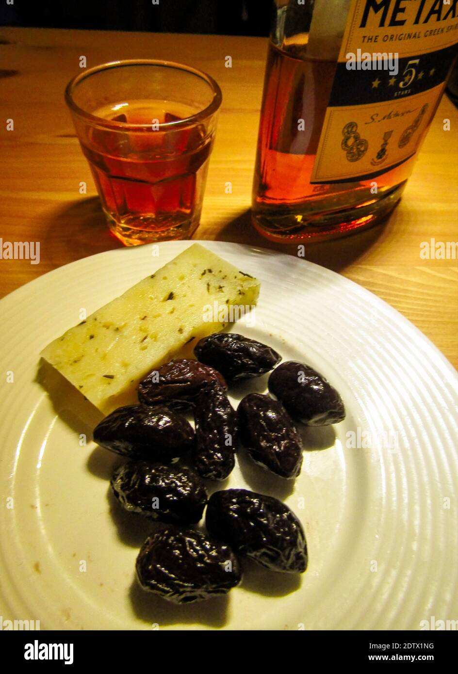 Meze from Crete. Olives, Graviera Cheese and Greek Brandy Stock Photo