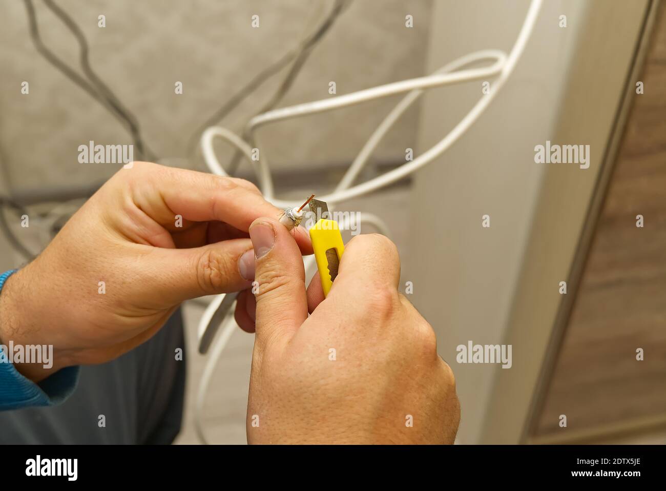 electrician connecting the cables of the television antenna during the