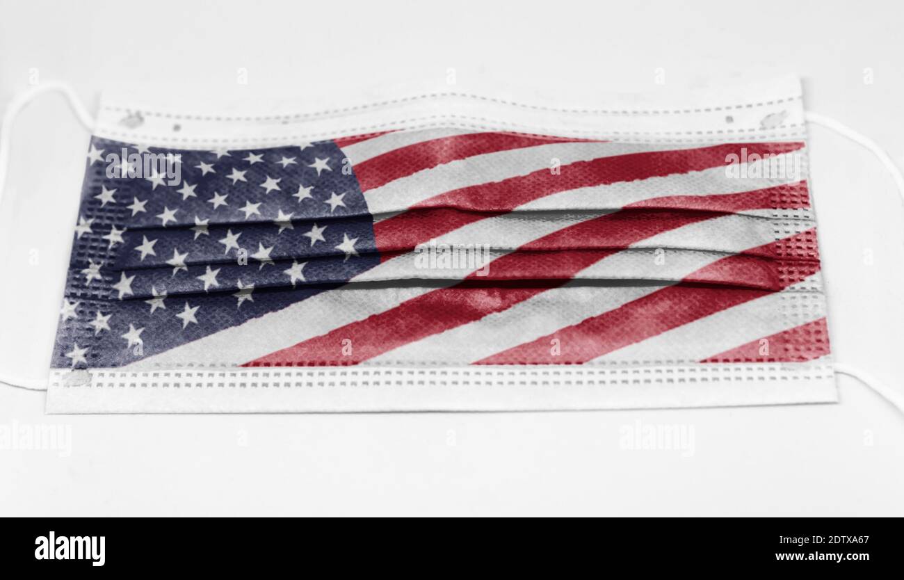 surgical mask with the USA national flag printed. Pandemic covid-19 and preventive measures to counter the spread of the virus Stock Photo