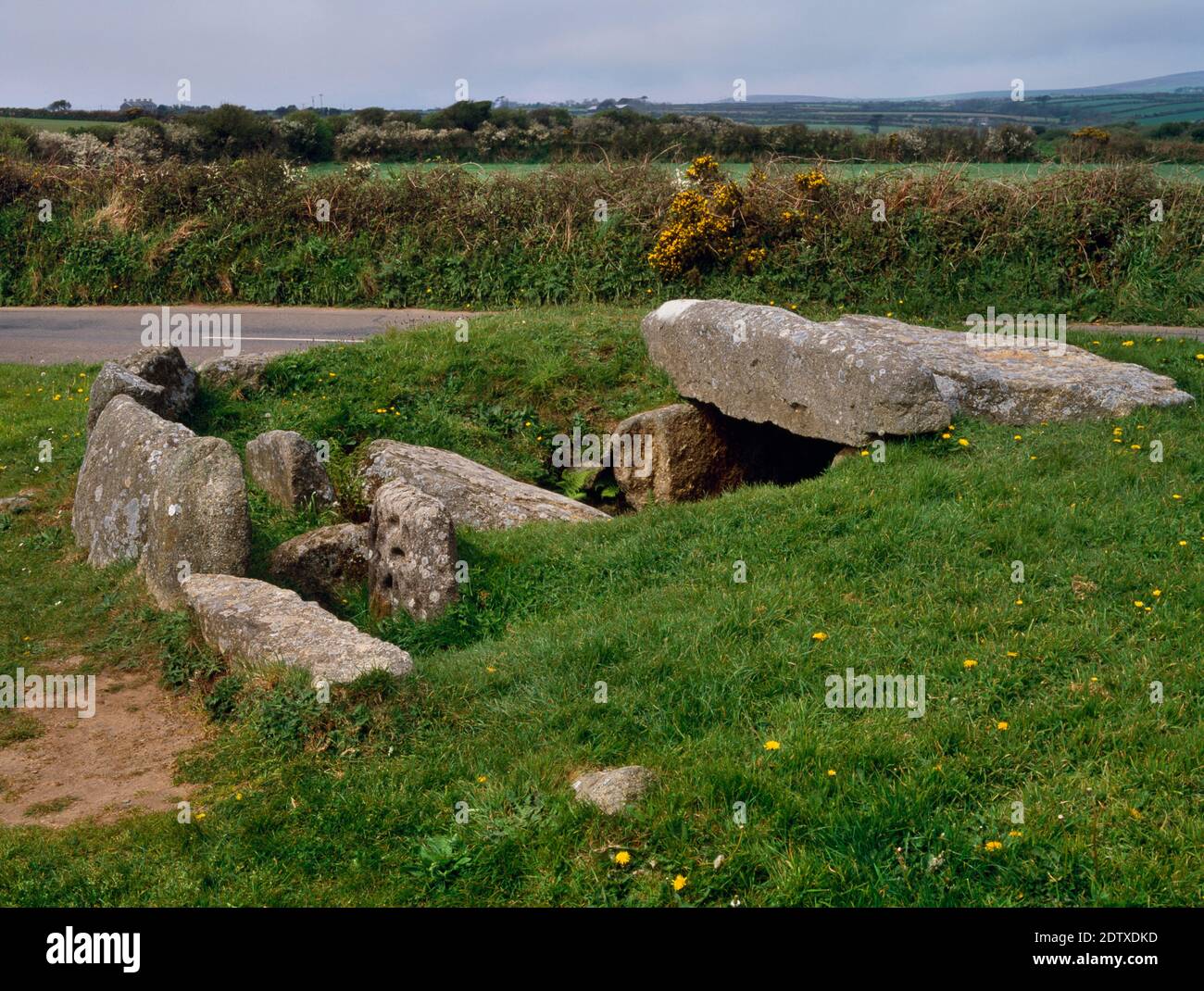 View NW of Tregiffian Burial Chamber, Cornwall, England, UK, showing the kerbed round barrow, cup-marked stone, entrance passage & central chamber. Stock Photo