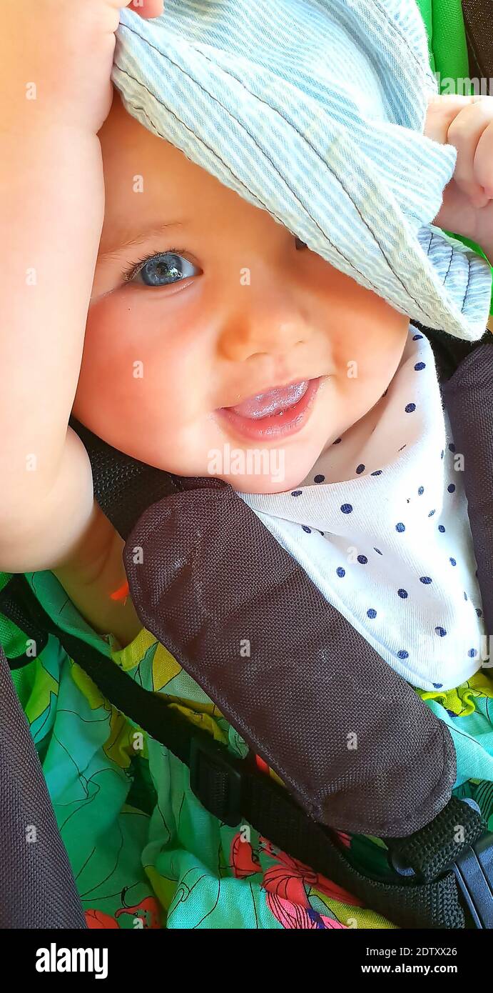 Close-up Portrait Of Smiling Baby Girl In Stroller Stock Photo