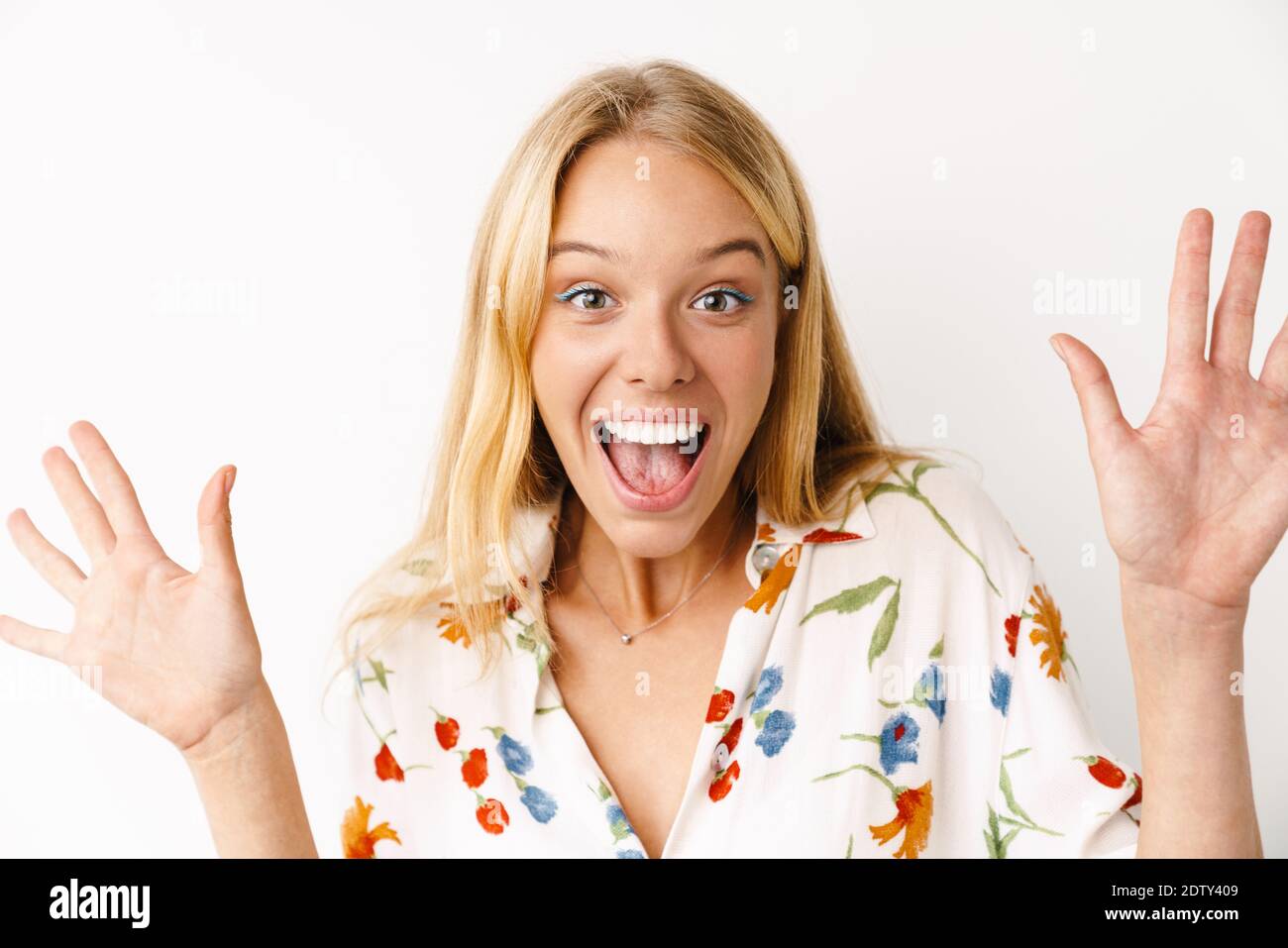 Excited beautiful girl expressing surprise at camera isolated over ...