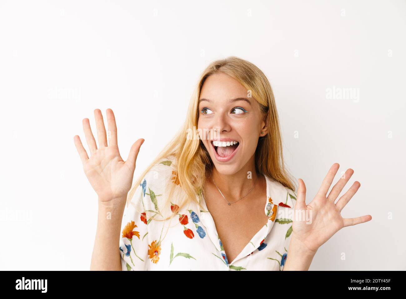 Excited beautiful girl expressing surprise at camera isolated over ...