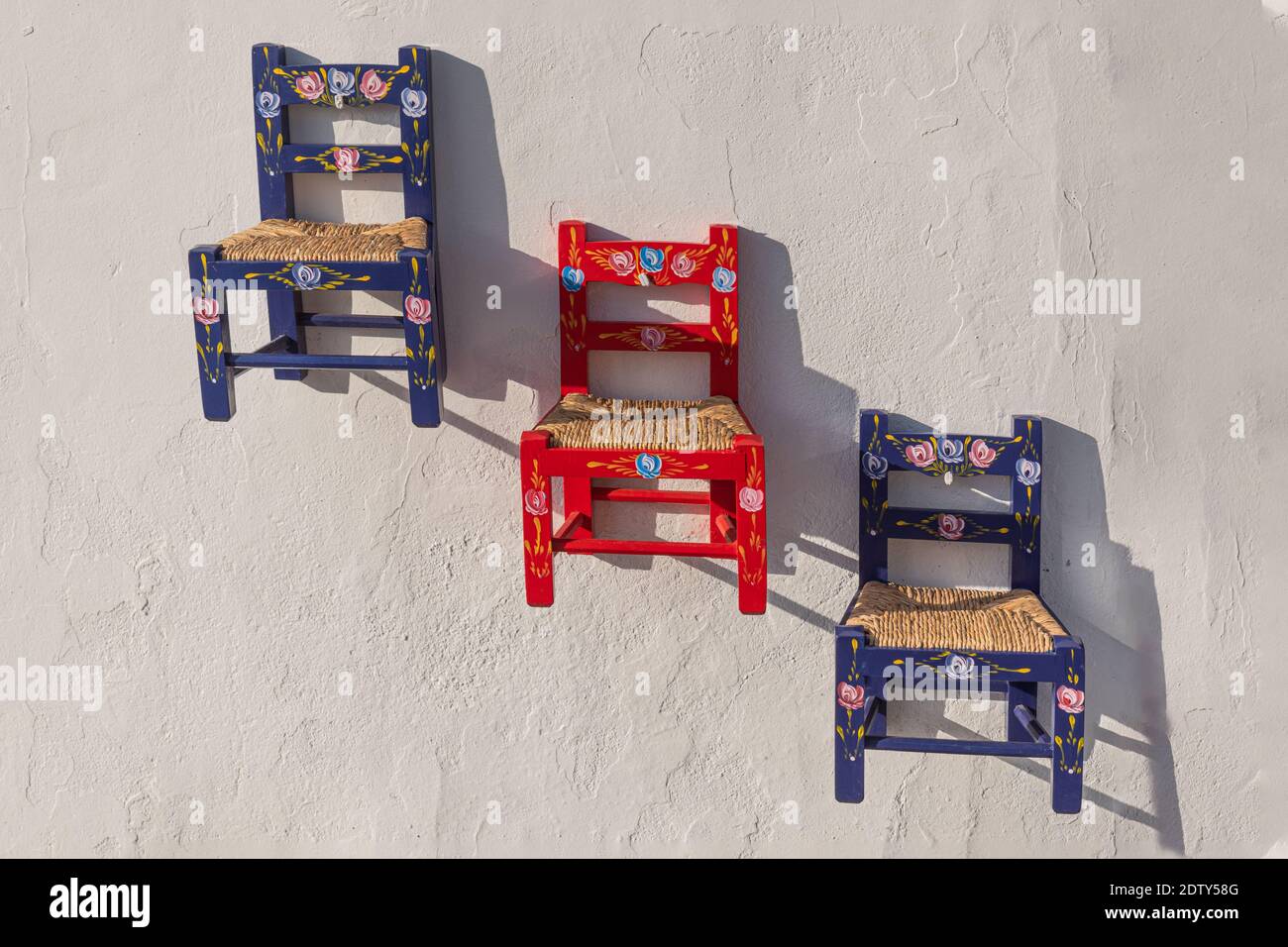 Chairs hanging on the white wall Stock Photo Alamy