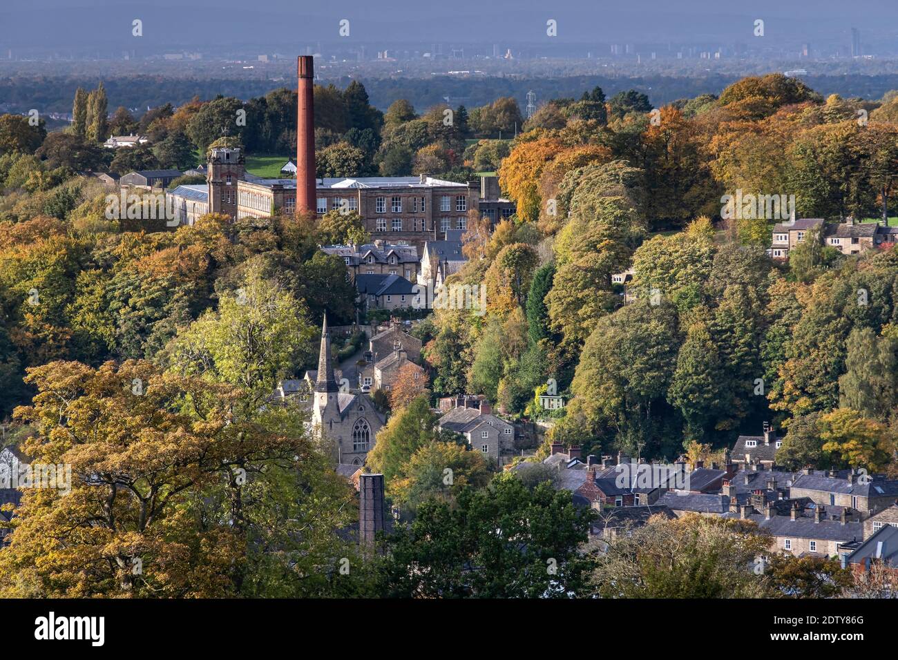 Clarence Mill, Bollington and distant city of Manchester in autmn, Bollington, Cheshire, England, UK Stock Photo