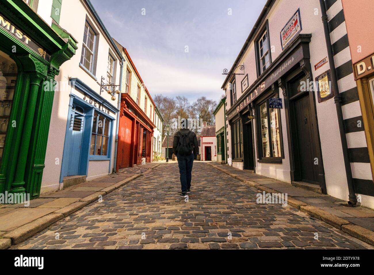 Omagh, County Tyrone, Northern Ireland 3-26-2017: The woman walking on empty streets of the old town of The Ulster American Folk Park Stock Photo