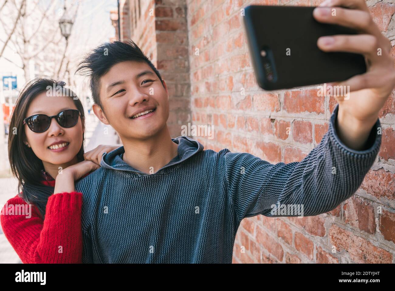 Asian couple taking a selfie with mobile phone Stock Photo - Alamy