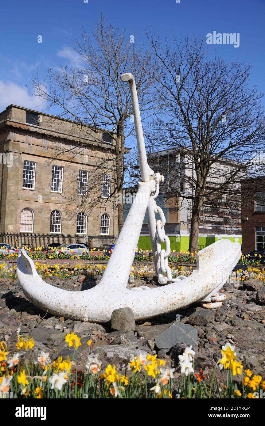 A large white ships anchor on display in Greenock, Scotland denoting the area's long historic connection with the shipping industry. Stock Photo