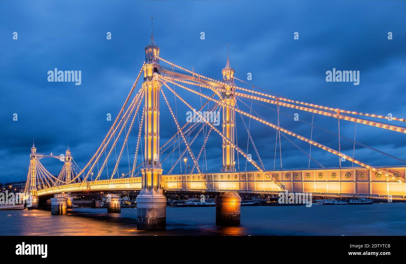 Albert Bridge is a cable stayed road bridge over the River Thames connecting Chelsea in Central London on the north, to Battersea on the south. Stock Photo