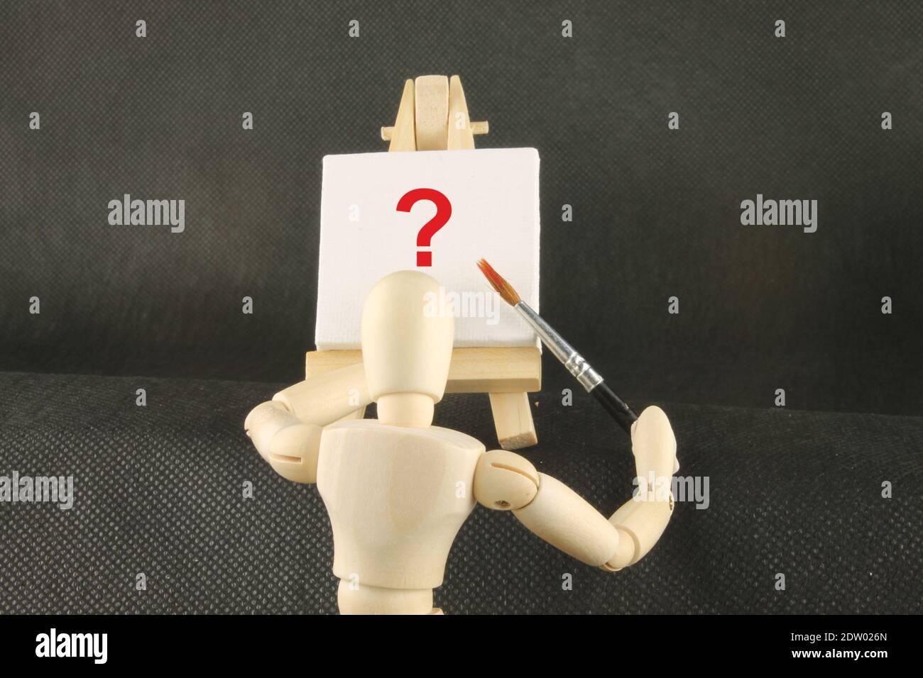 Mannequin in front of an easel with a red question mark, Artist's block concept Stock Photo