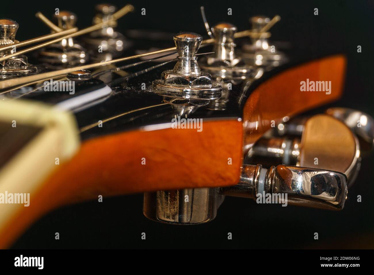 Close-up of a guitar head with mechanics and strings Stock Photo