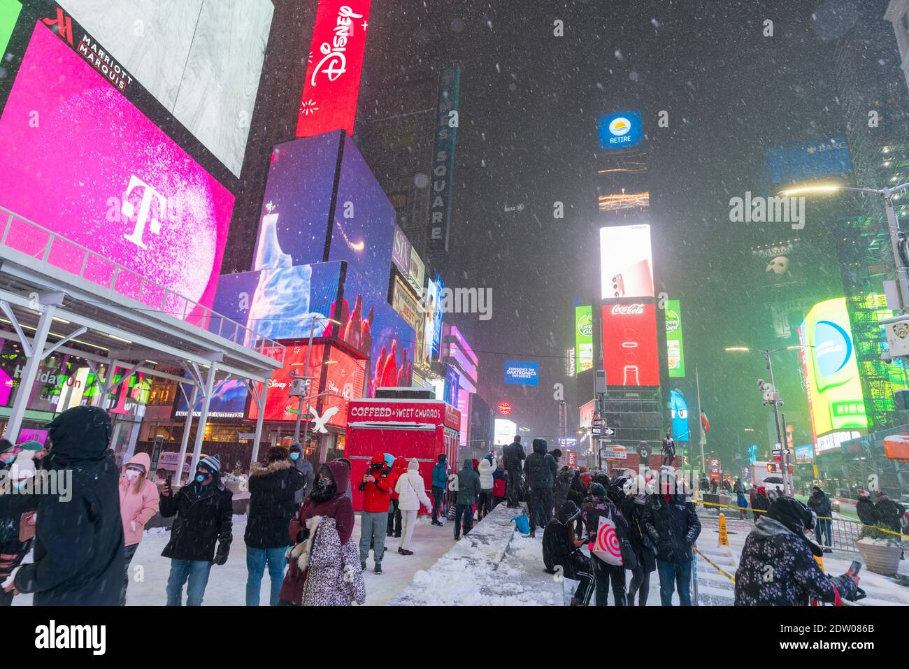 Tourists and visitors enjoy during the First winter storm hits in Times Square. Stock Photo