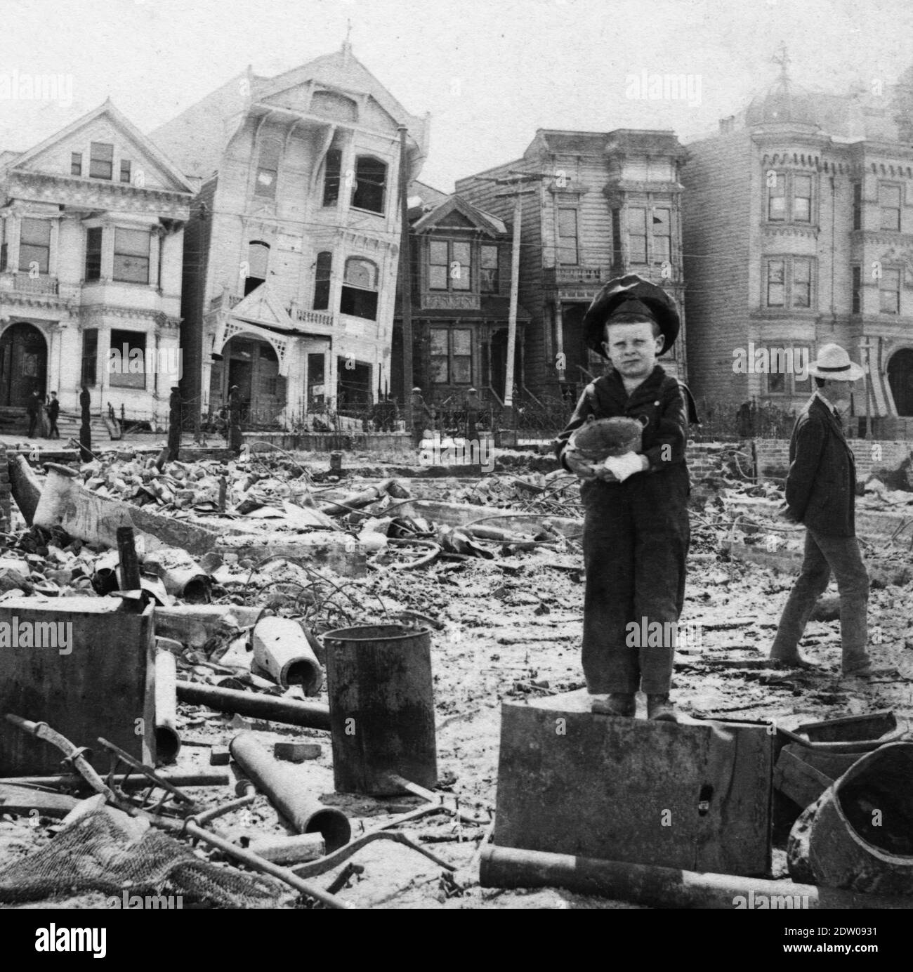 The Great 1906 San Francisco [California] earthquake happened on April 18, 1906.  It hit with an estimated magnitude of 7.9.   The little boy holds a small pail. These two people are unidentified.   The earthquake was felt from southern Oregon to south of Los Angeles and inland as far as central Nevada.   To see other images of noteworthy places, search:  prestor   vintage   places Stock Photo