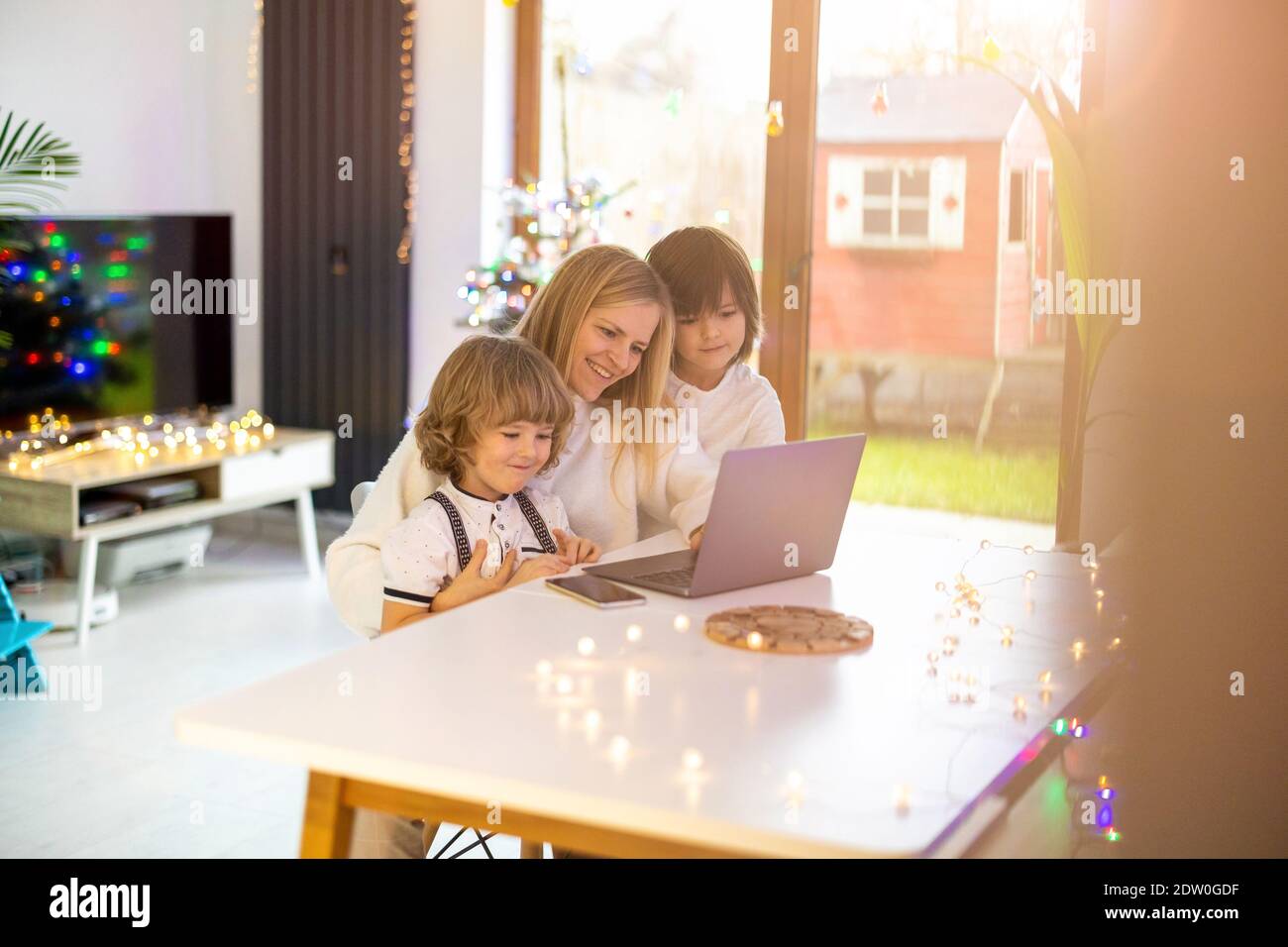 Mother trying to work from home with her kids as a company Stock Photo