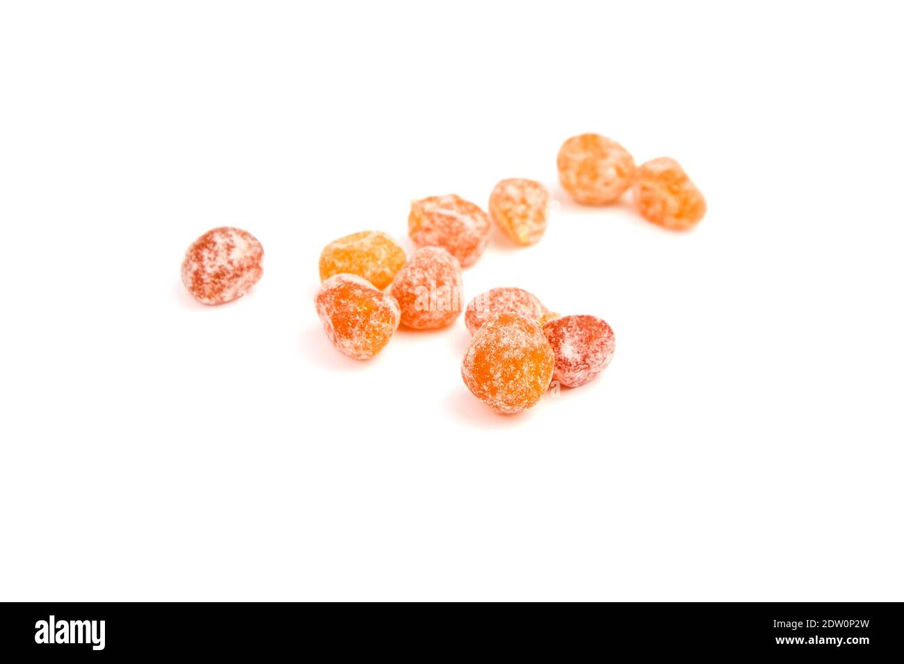 Candied kumquats, heap of dried fruits isolated on white background. Sugar coated kumquats Stock