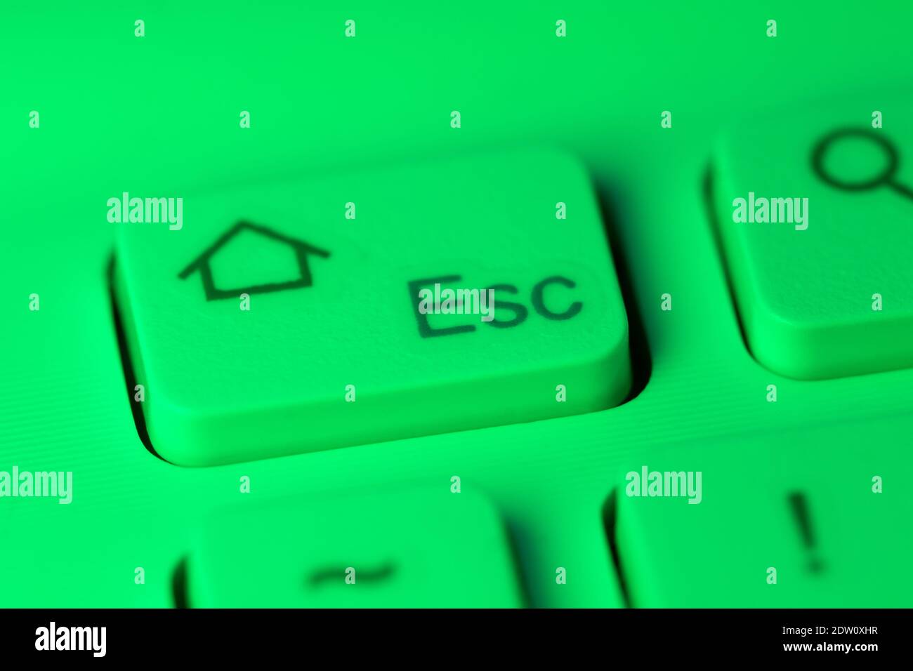 Close up detail of a green highlighted escape key on a computer keyboard Stock Photo